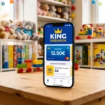 Smartphone affichant l'application de fidélité King Premium posé sur une table dans un magasin King Jouet.